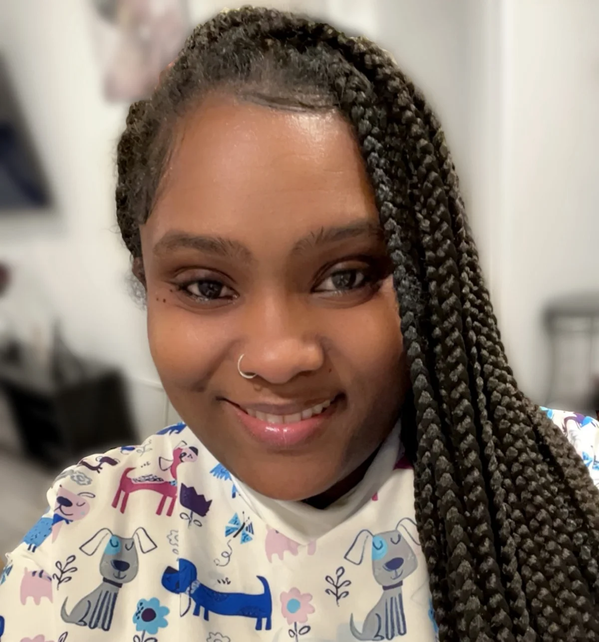 Kadian, newborn and postpartum specialist in New York, smiling at the camera.