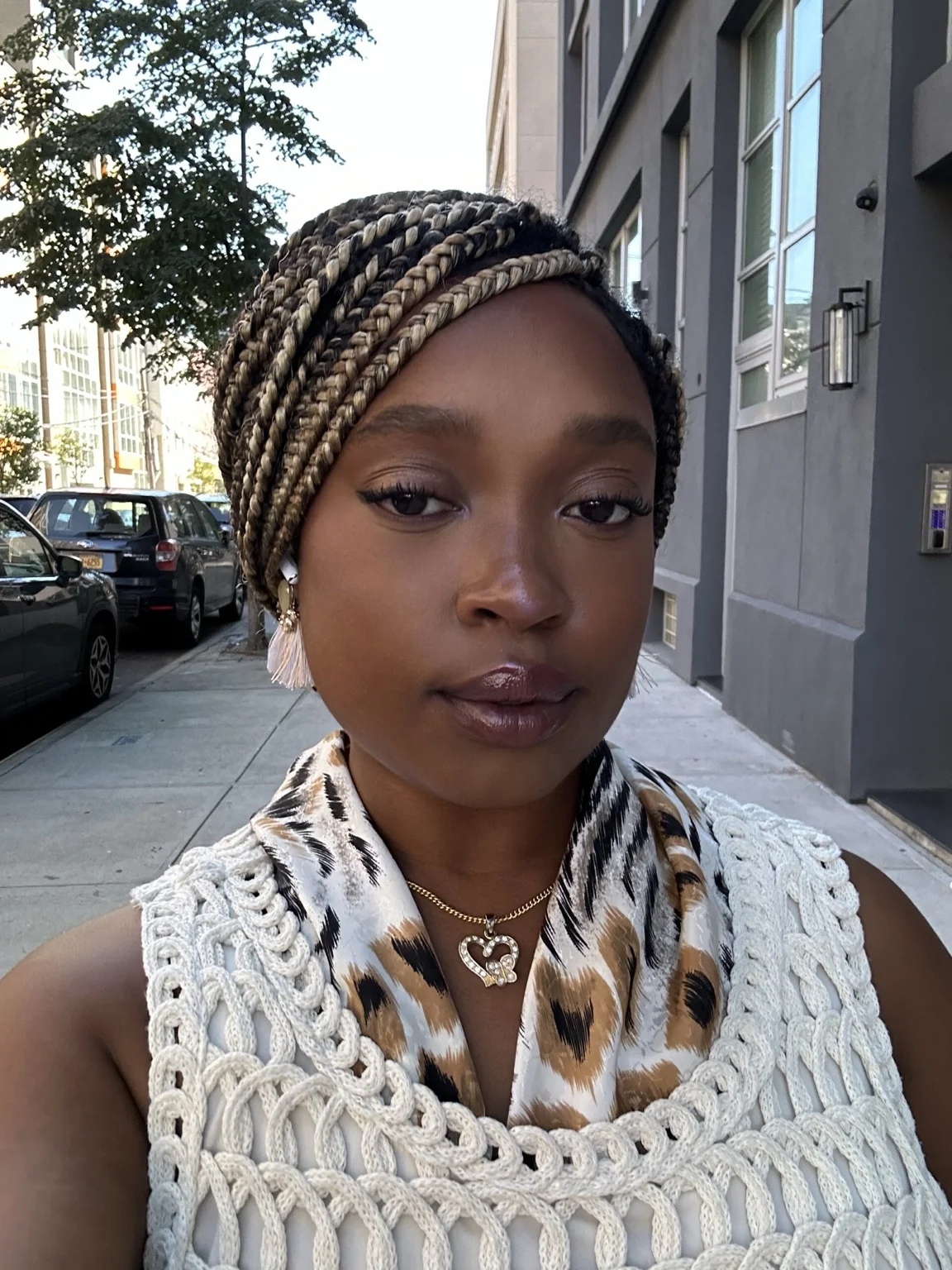 Sierra, certified full-spectrum doula in NYC, standing outdoors and smiling softly.