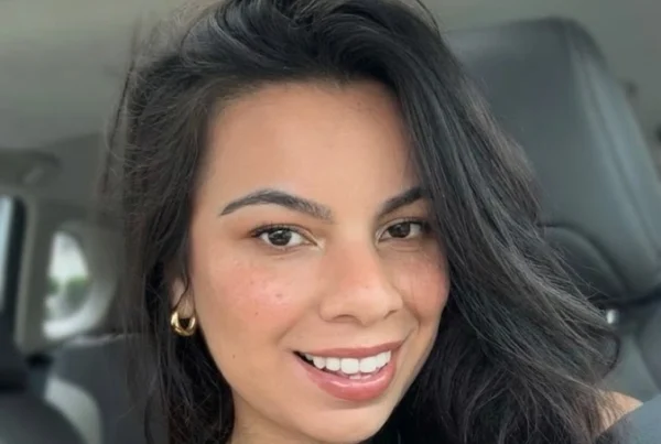 Portrait of Leticia, a certified postpartum and overnight doula in New York City, smiling in professional attire.